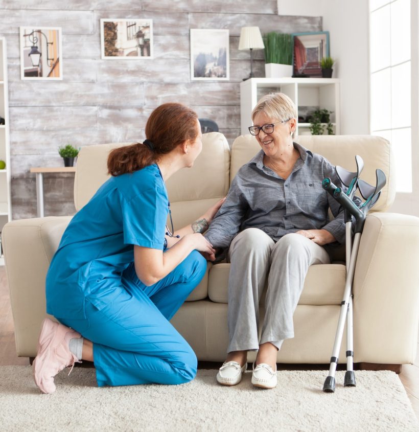 Female nurse talking with a female client in the comfort of her home.