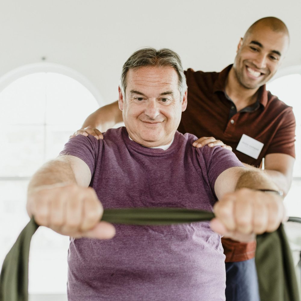 Home Health wellness aide gives a massage to an elderly client inside the comfort of his home.